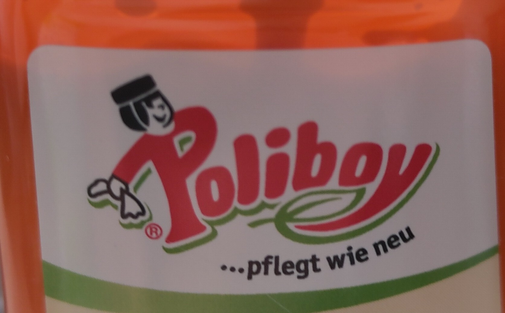 label on an orange bottle of furniture polishing: "Poliboy ... pflegt wie neu"