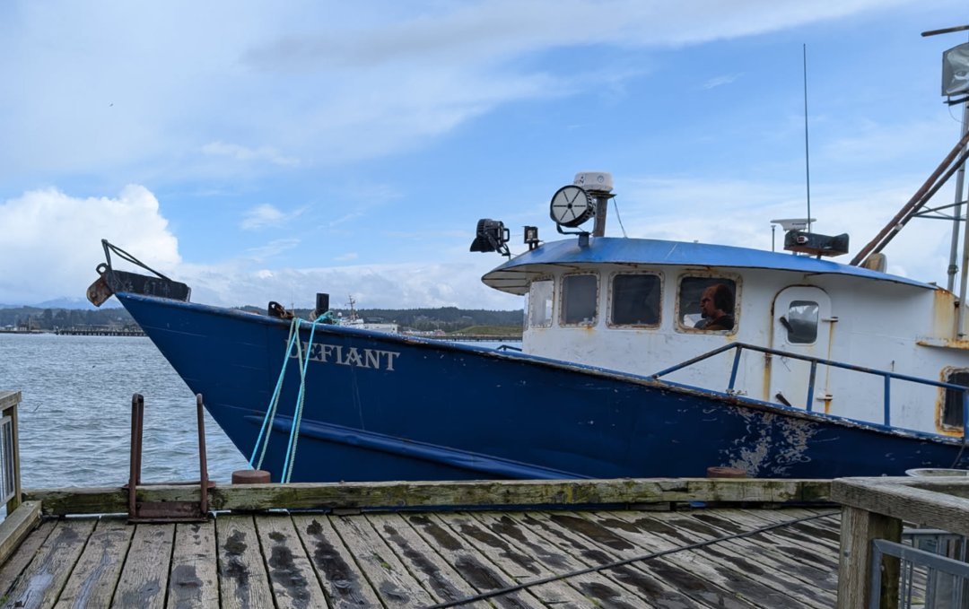 A fishing ship named Defiant with Warf at the helm.